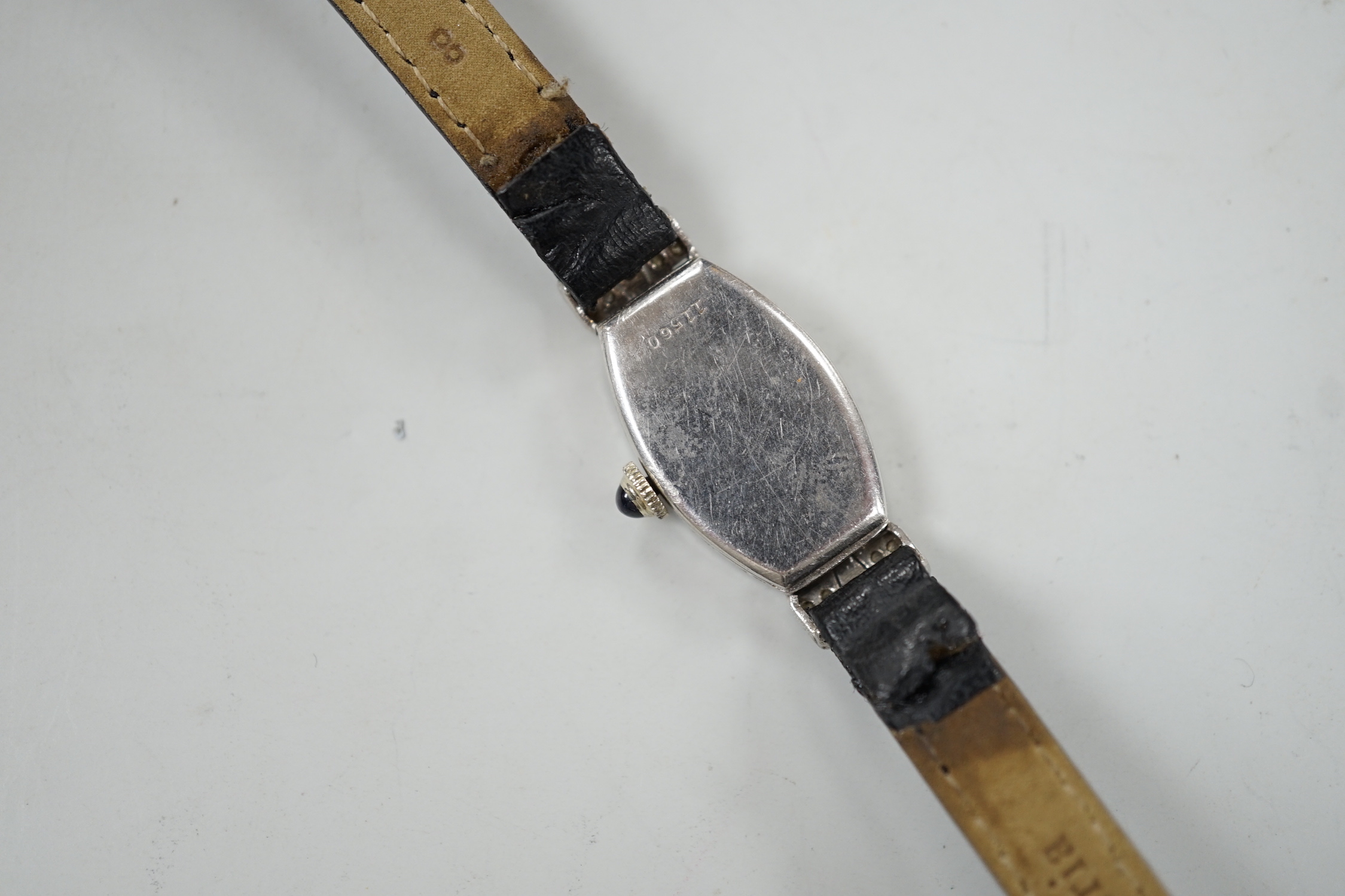 A lady's platine and diamond cluster set manual wind cocktail watch, on a leather strap.